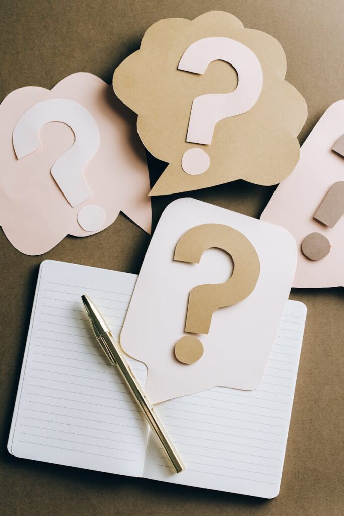 pexels-photo-5428830-5428830 Flat lay of question mark paper crafts on a notebook, symbolizing questions and ideas.